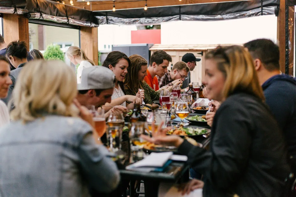 A team sharing dinner and drinks at a restaurant after their escape room